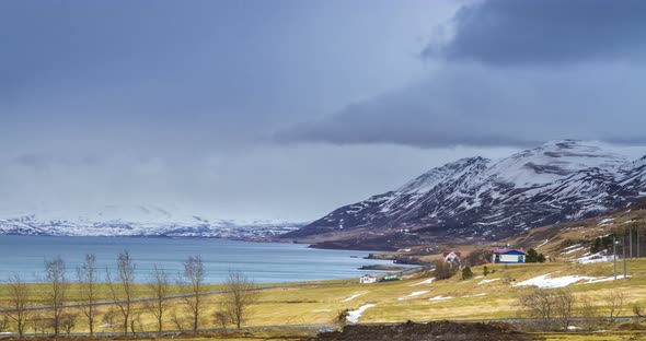 Cloud rolling time lapse over snow mountain fjords in Akureyri, Iceland.