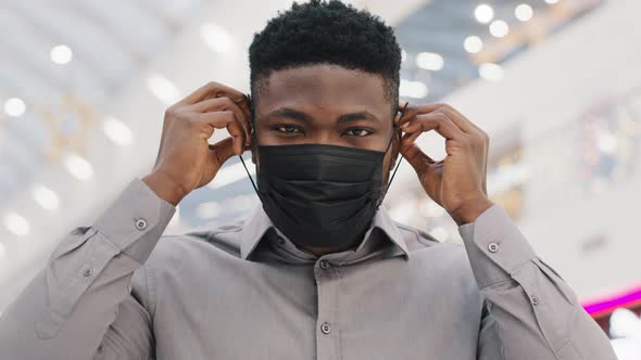 Closeup Young African American Man Wearing Medical Mask Protects From Illness During Pandemic Posing alt