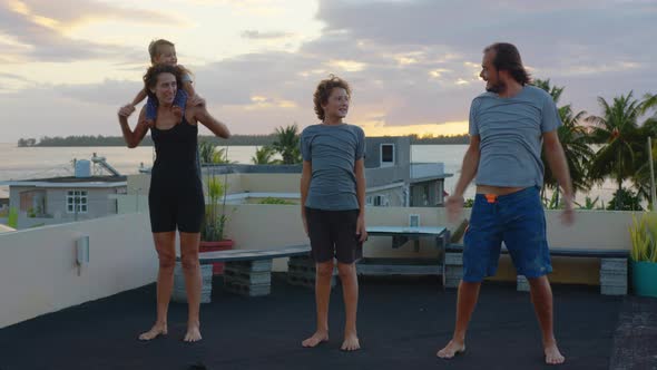 Cinematic Shot of Happy Smiling Family with Children Doing Exercises of Gymnastics Together at alt