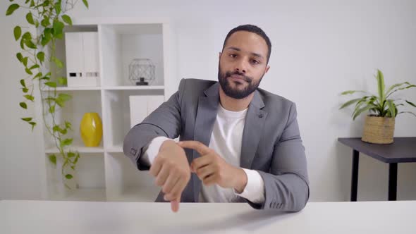 Webcam View of a Video Conference of an AfricanAmerican Businessman Looking at the Camera and alt