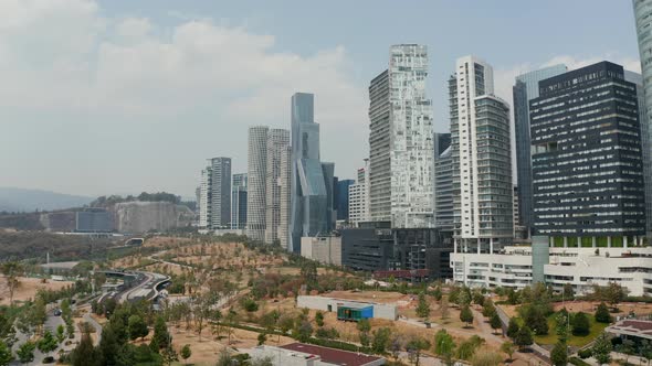 Landing Footage in Public Park Next to Modern Skyscrapers in Santa Fe District alt