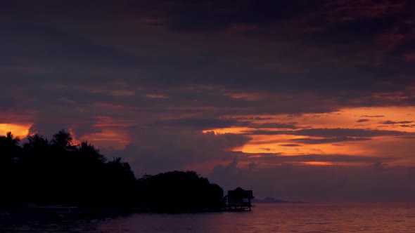 Colorful Sunset on a Tropical Coast and Motorboat