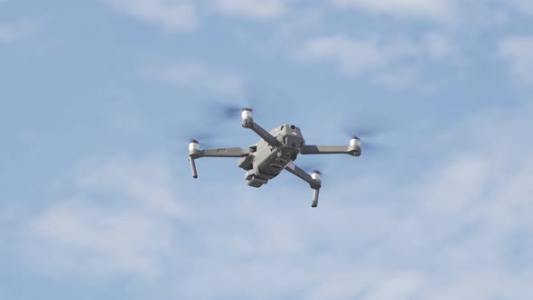 Aerial view of a professional drone with propellers flying with camera alt