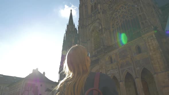 Woman tourist and St Vitus Cathedral in Prague alt