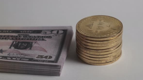 A Stack of Bitcoin and a Wad of Dollars alt