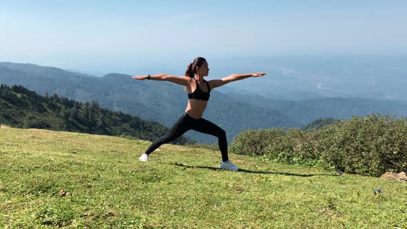 Woman Practicing Yoga on a Mountains