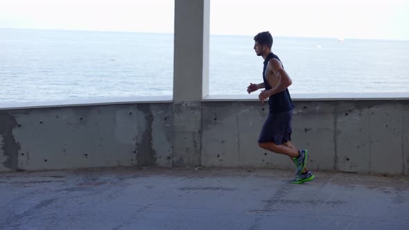 Man Runs Around By Levels of an Empty Parking Garage alt
