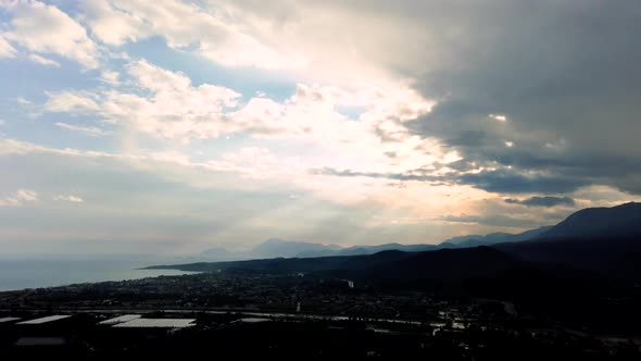 Time lapse panorama of sun and rain above green valley and seashore