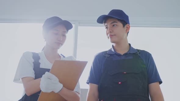 Asian construction worker people  walk in work site, examine and check renovation in house. alt