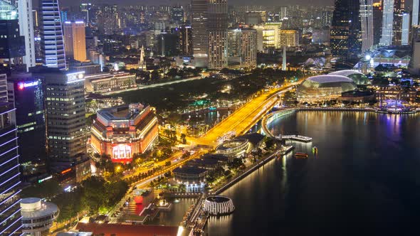 Aerial View of Singapore Skyline and Skyscrapers with Road Traffic at Night alt