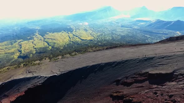 Aerial Shot Flying Backwards of Climbers on Summit of Mount Rinjani On Lombok In Indonesia at Sunris alt