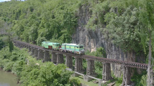 Aerial view of Thai local old classic train on railway on River Kwai Bridge alt