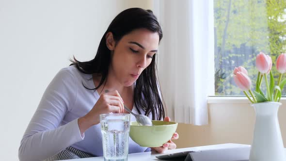 Beautiful woman having breakfast alt