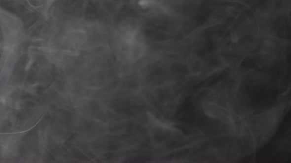 Smoke texture over blank black background. Mystical steam at night. alt