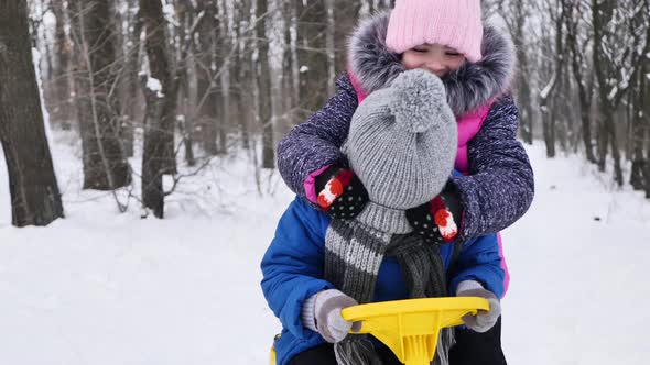 Friends a Boy and a Girl Playing in the Winter Forest