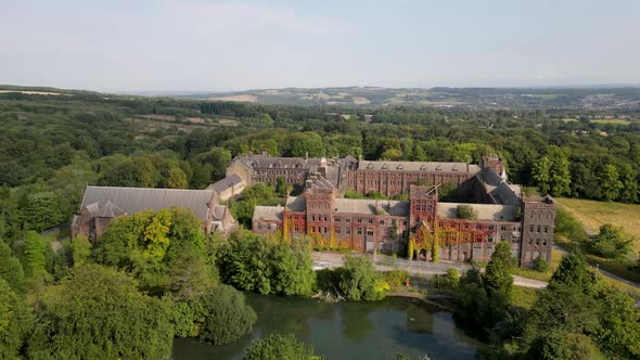 Aerial Footage Flying Towards an Ivy Covered Abandoned Building