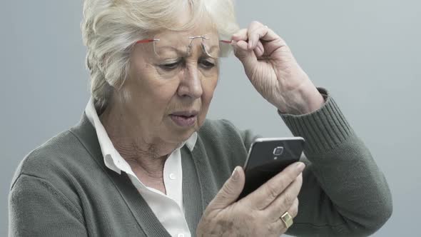 Senior woman with vision problems using a smartphone