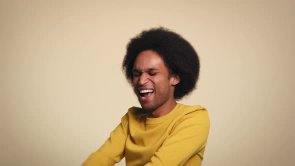 African young man is dancing with joy in studio shot. Shot with RED helium camera in 8K. alt