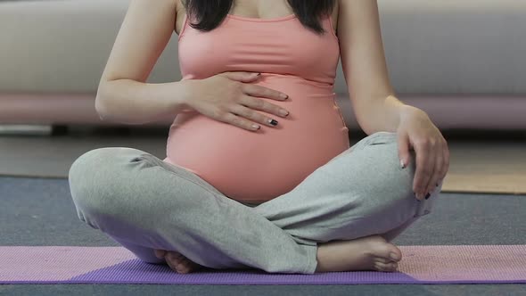 Pregnant Lady Sitting on Floor, Breathing Technique, Preparing for Childbirth alt