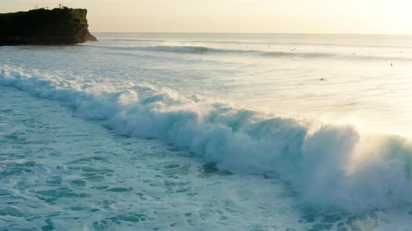 Following large waves at sunset