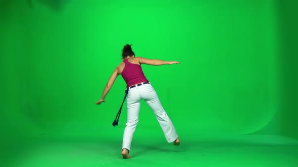 Brunette Female Practicing Capoeira on Green Screen. Slow Motion. alt
