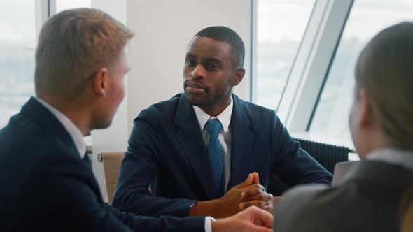 Corporate leader manager communicating with his team about a new project alt