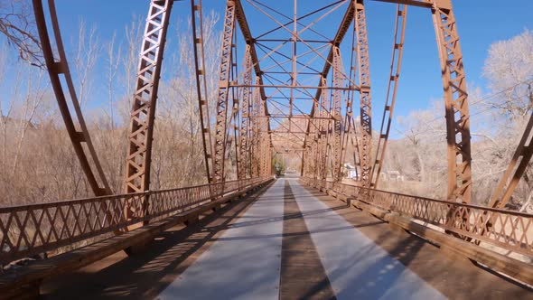 Driving on the Rockville Bridge over the Virgin River in Utah alt