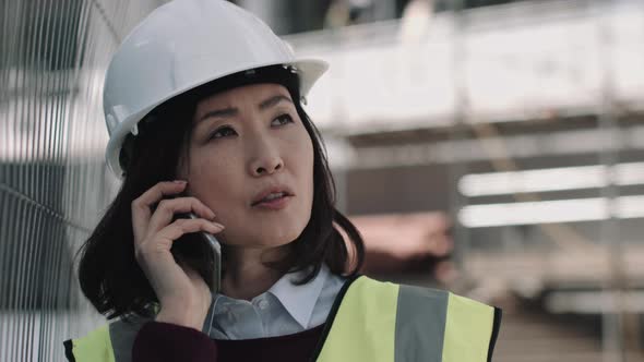 Architect speaking on phone on construction site