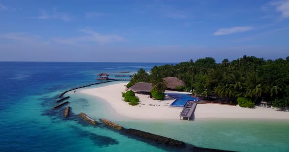 Tropical birds eye copy space shot of a sandy white paradise beach and aqua blue water background in alt