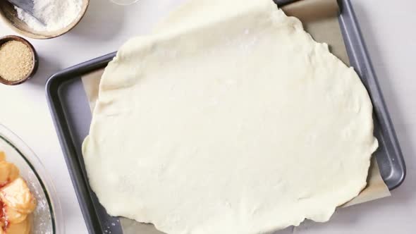 Time lapse. Step by step. Making peach galette with fresh local peaches. alt