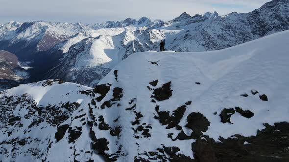 Aerial View of Cheget Mountain Range in Snow in Winter in Sunny Clear Weather alt