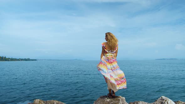 Girl in a Beautiful Dress Is Standing on the Coast alt