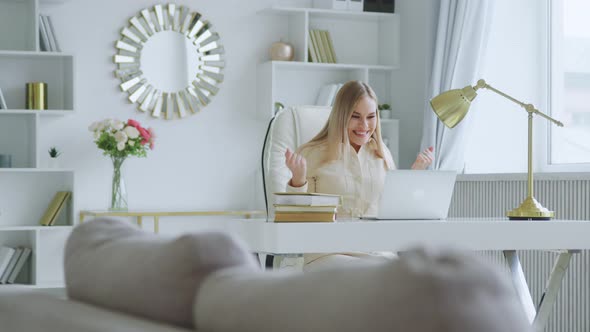 Young girl emotionally rejoices at good news at home office alt