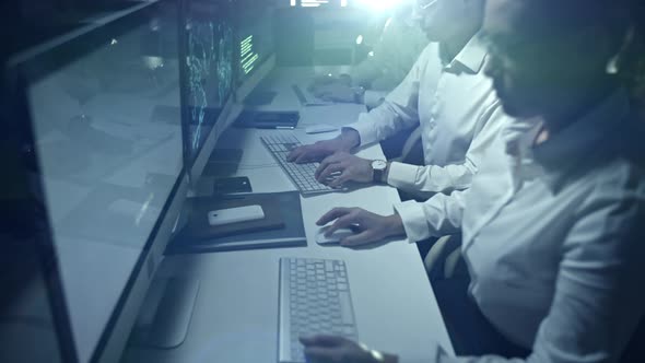 Cyber Security Professionals Working at Night alt