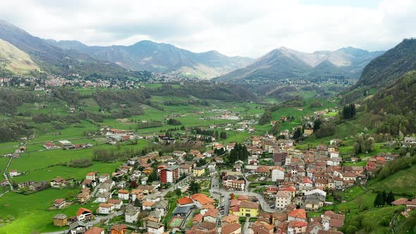 Aerial Video of the Small Town of Pasturo in Lombardy North Italy Showing Mountain Panorama Forest alt