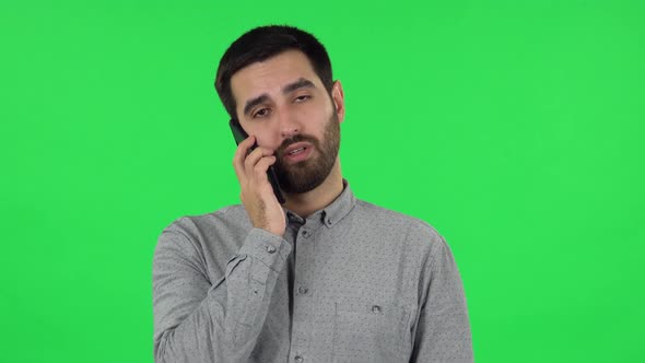 Portrait of Brunette Guy Is Talking for Mobile Phone. Green Screen alt