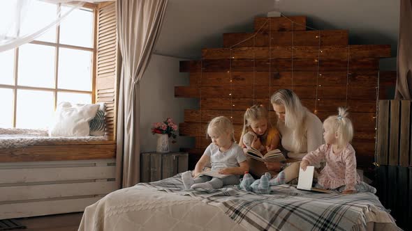 Woman Reading Book for Three Kids Girl Inside Cozy Room alt