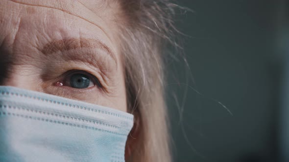 Eye of an Senior Woman with Wrinkled Skin Under Medical Mask alt