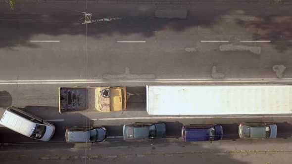 Aerial top down view of busy city street with traffic cars during rush hour. alt
