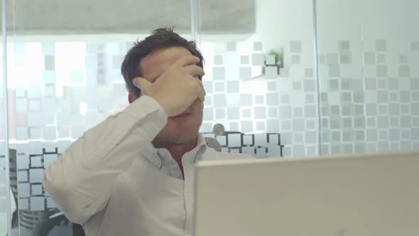 Man looking at computer in disbelief