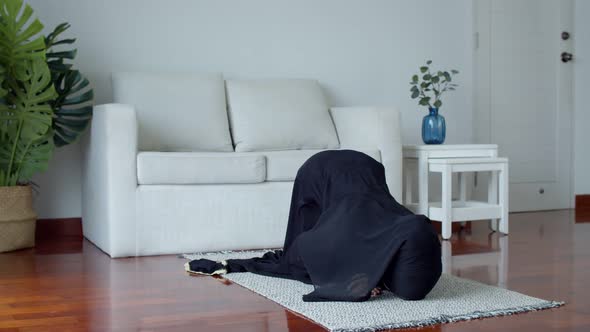 Young Muslim female praying and practicing the Islamic faith
