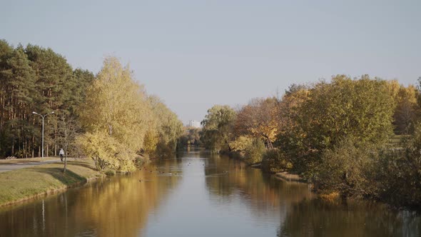 Beautiful View of City Autumn Park with River on Sunny Day alt