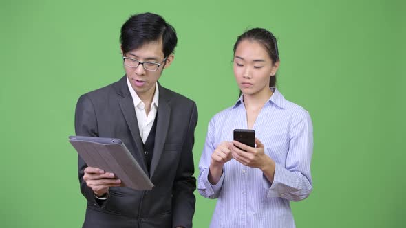 Young Asian Business Couple Having Meeting Together