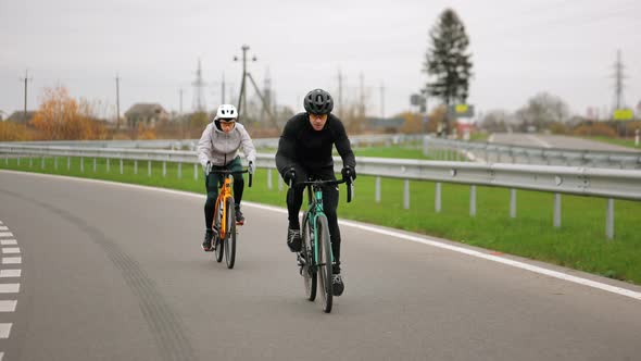 Two Cyclists are Training on the Track alt