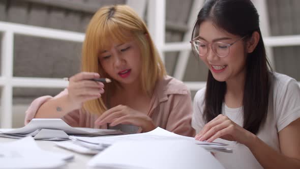 Group of young friends undergraduate girl looking books for information and knowledge. alt