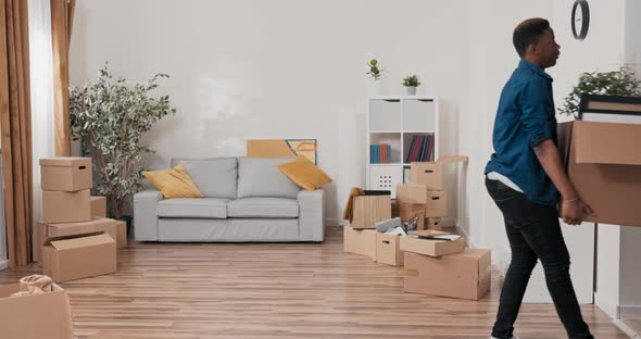 A Young Couple in Love Bring Heavy Boxes of Packed Belongings Picture Frames Into Their Purchased alt