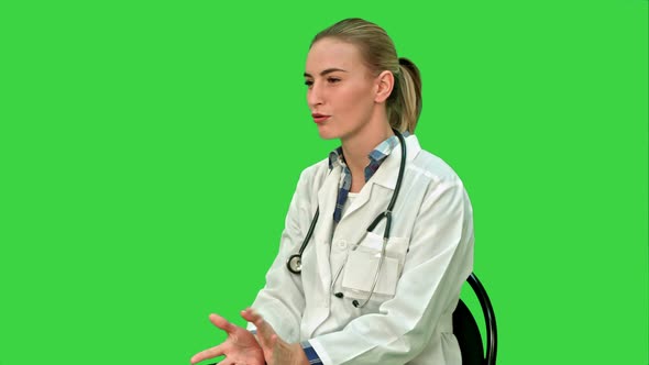 Doctor Have a Positive Conversation with a Patient, Sitting on a Green Screen alt