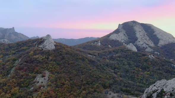 The Flight Between Mountain Peaks Towards Sunset Over the Sea