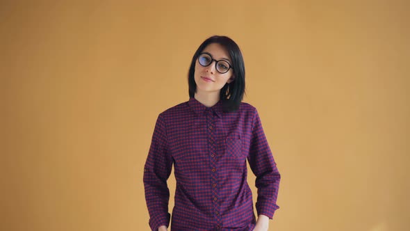 Portrait of Good-looking Woman in Glasses Winking and Smiling Looking at Camera alt