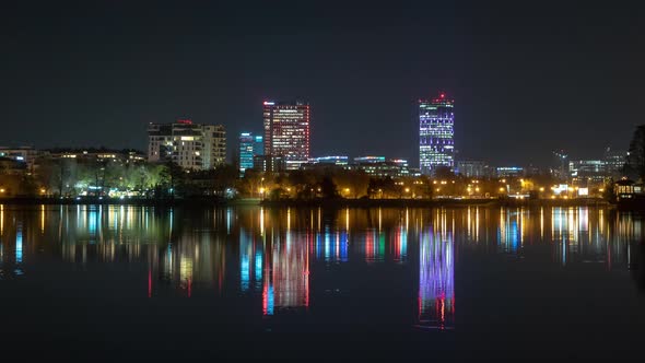 Bucharest city skyline time lapse with reflections in the lake ,Romania alt